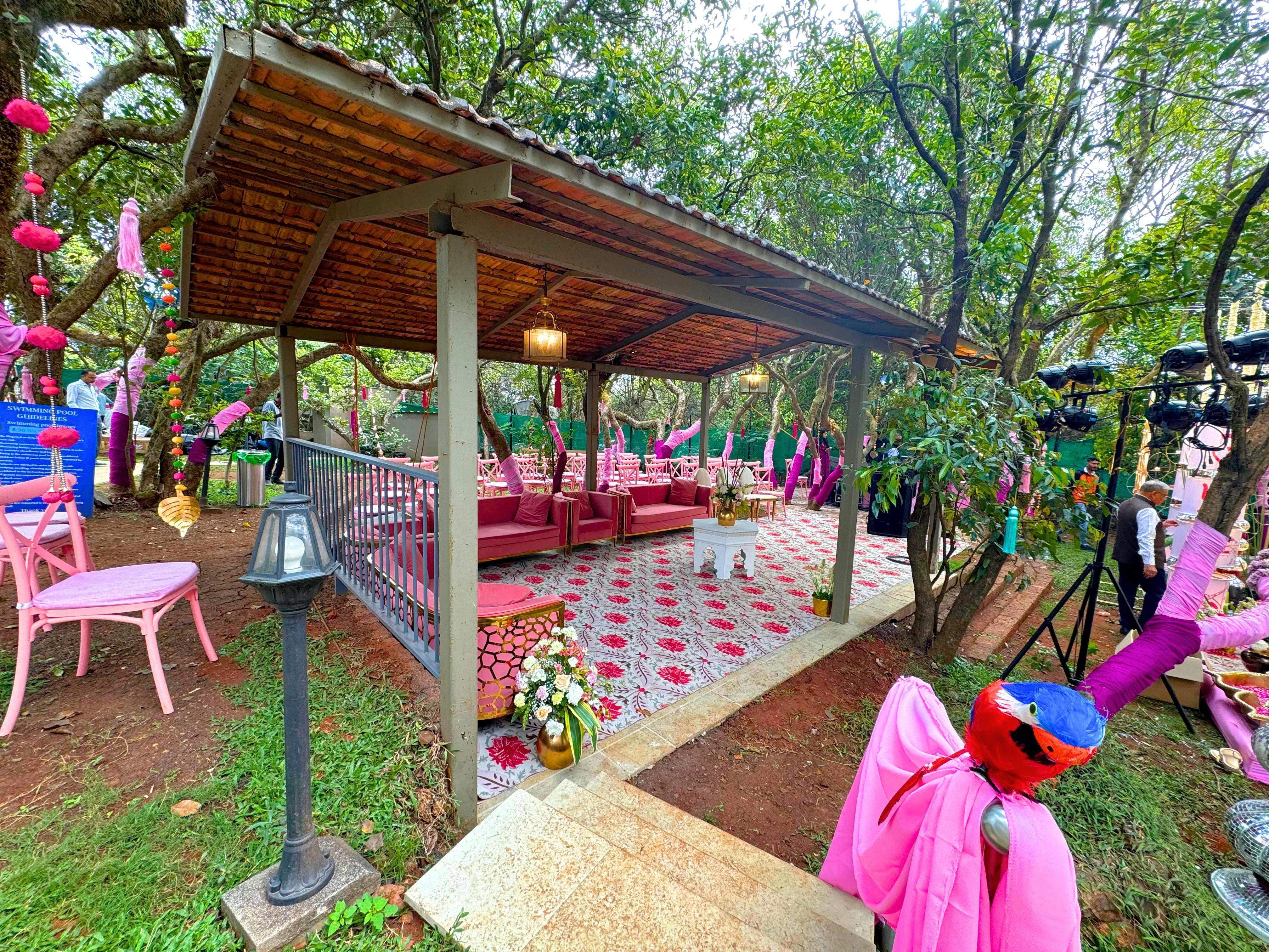 Tree canopy wedding setup with detailed decor and seating arrangements at Advait Resort.